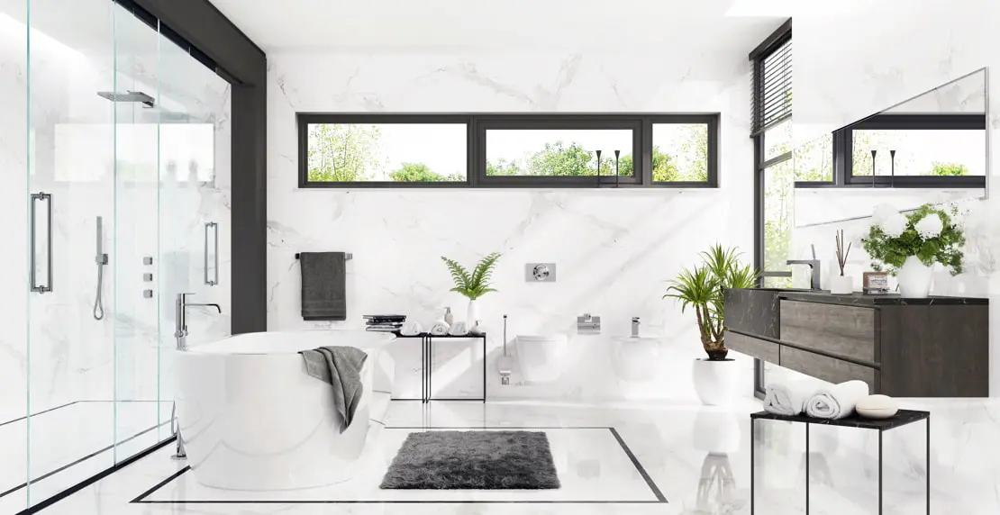 Luxusní koupelna s vanou a sprchou, která má průhledné sprchové zástěny