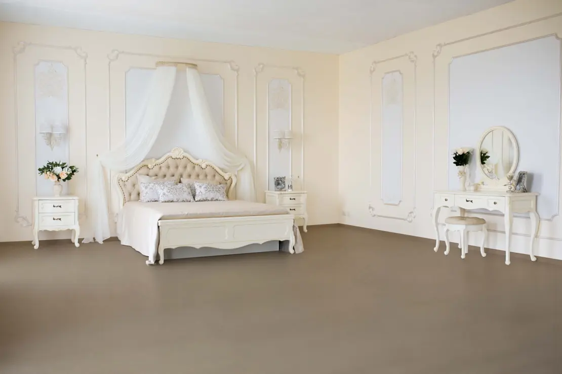 Luxusní pokoj s mikrocementovou podlahou, která zvyšuje prostor a klasický styl místnosti