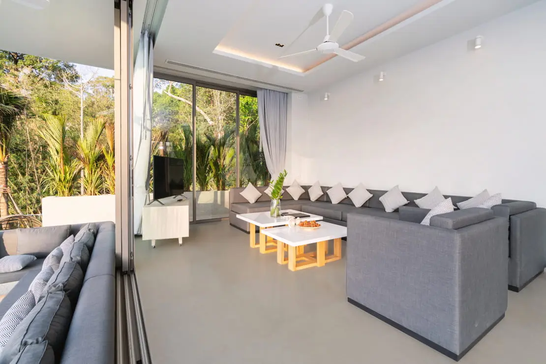 Living room with large windows and microcement floor