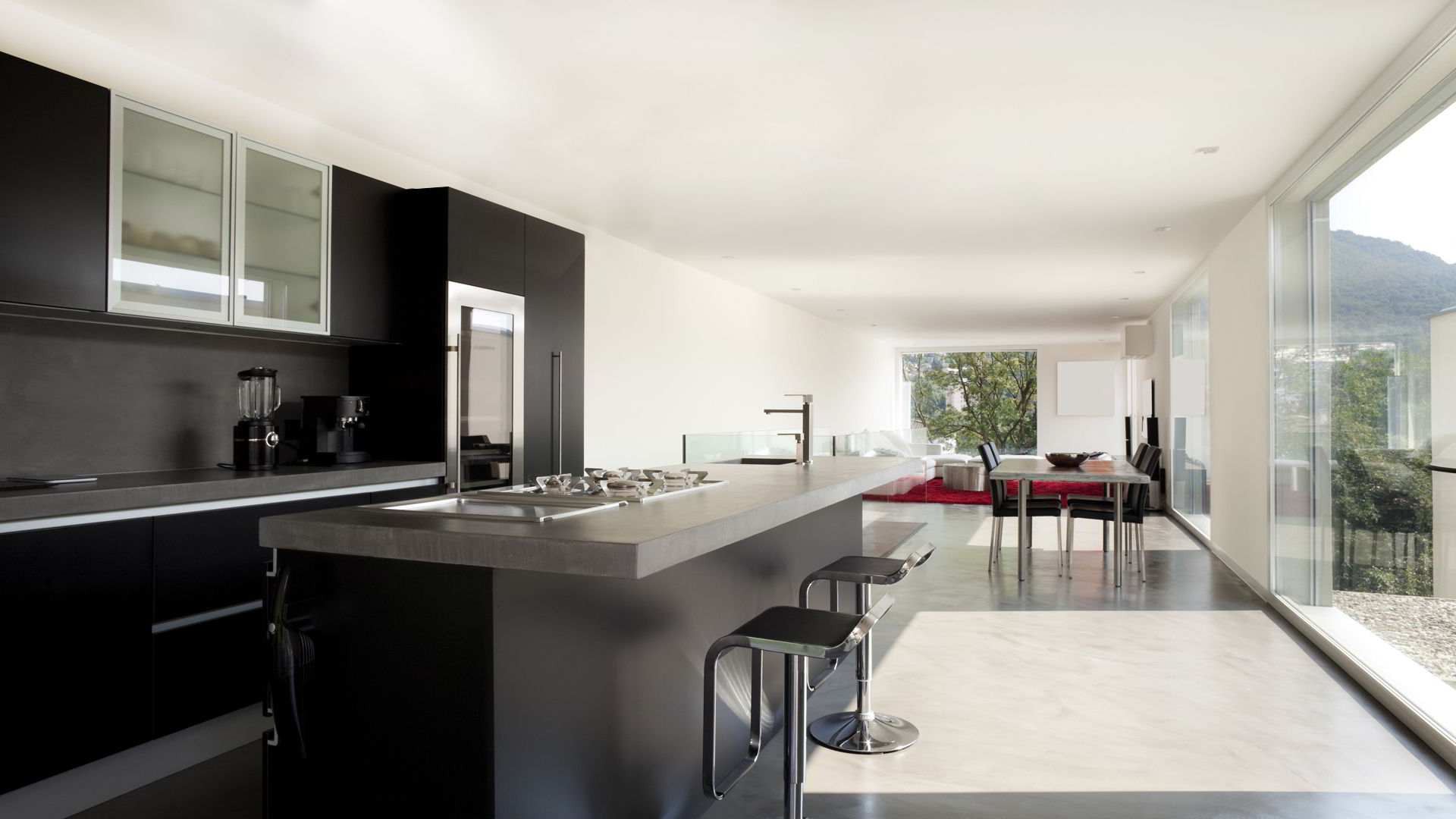 Integrated kitchen in living room with microcement floor