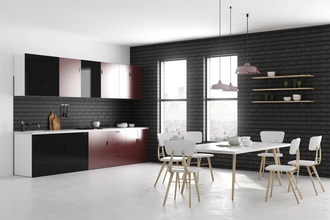 Dysheme e mikrocementit në një kuzhinë me mure të tulla të dukshme dhe mobilje që kombinon të zezën me të kuqen